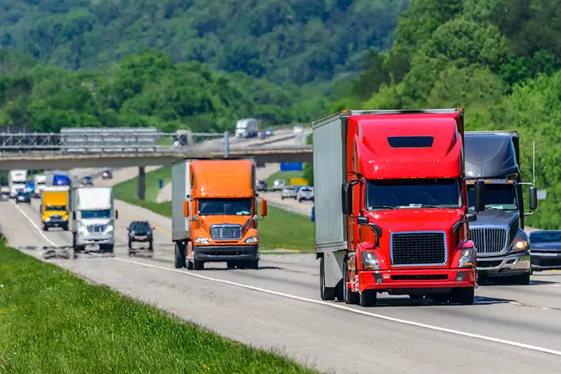 Big trucks driving on a busy highway